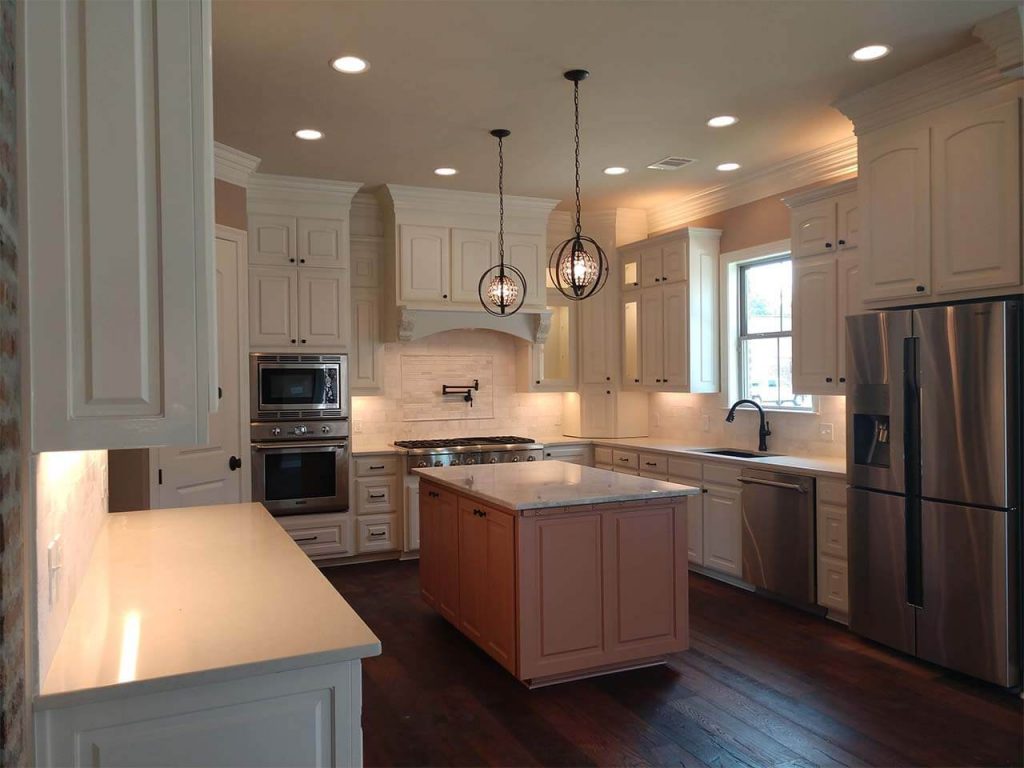 Kitchen with white cabinets and iron lighting